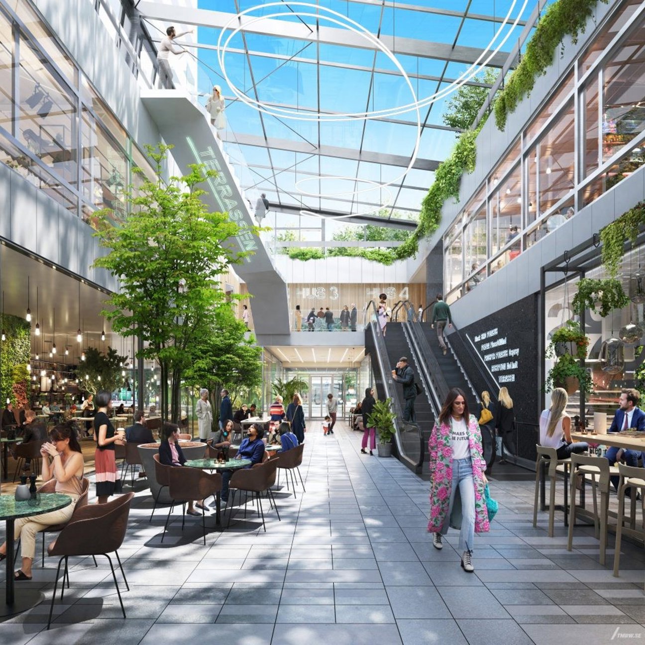 Inomhusgalleria med glastak, trappor, bord och människor.